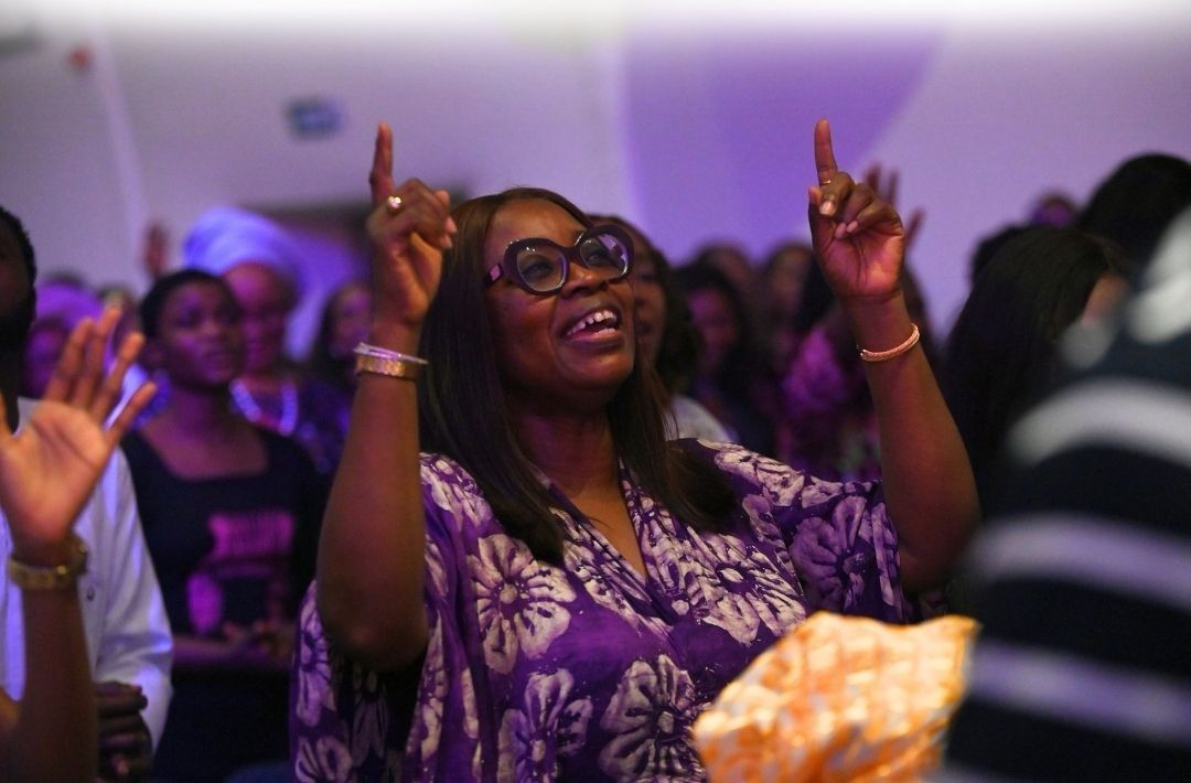 A woman worshipping with both hands raised
